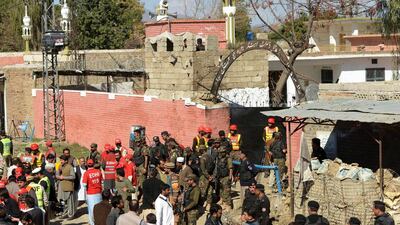 Pakistani security personnel gather at the main entrance of a court complex after multiple Taliban suicide bomb attacks in the Tangi area of Charsadda district on February 21. Abdul Majeed / AFP