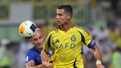 Al Nassr's Cristiano Ronaldo battles with Esteghlal's Raphael Silva.