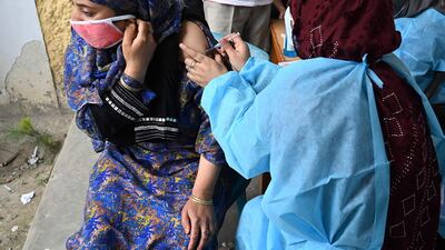 A health worker administers a dose of the Covaxin coronavirus vaccine to a woman at a centre in Srinagar, Jammu and Kashmir. AFP