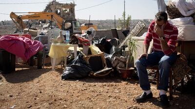 A Palestinian with his belongings after his home in East Jerusalem is demolished. Getty Images