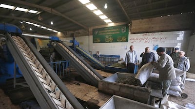 Workers pour olives into a grinding machine before they are pressed into oil at an olive press factory in Irbid city, north of Amman. A lack of rain and higher temperatures this year has cut the harvest of the olive fruit by about 20 percent from last year. Muhammad Hamed / Reuters