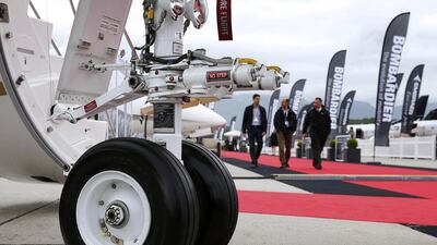 Visitors walk past aircraft on display. Denis Balibouse / Reuters