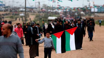 A boy carries national flags at a demonstration. AFP