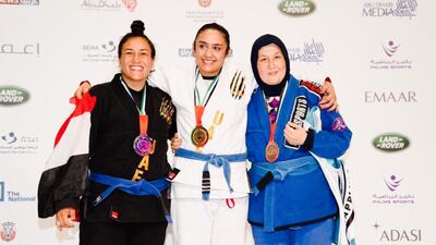 Ishtar Azzawi, centre, says she has received great support from both Iraqi men and women since winning gold in Abu Dhabi.