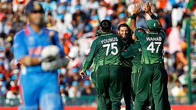 Pakistan's players celebrate the dismissal of Sachin Tendulkar in Mohali. Aijaz Rahi / AP Photo