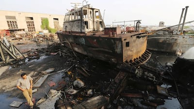 A worker walks past a tug damaged by an air strike on the maintenance hub at the Hodeida port, Yemen May 27, 2018. Abduljabbar Zeyad / Reuters
