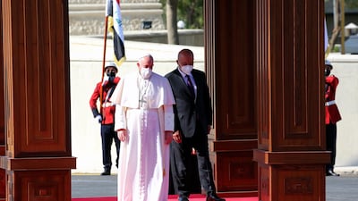 Iraqi President Barham Salih welcomes Pope Francis during an official welcome ceremony at the Presidential Palace in Baghdad. EPA