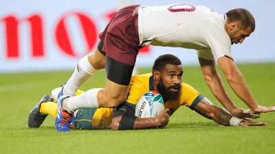 Australia's Marika Koroibete scores a try despite the attentions of Lasha Khmaladze on Friday in the Rugby World Cup Pool D in Shizuoka. AP