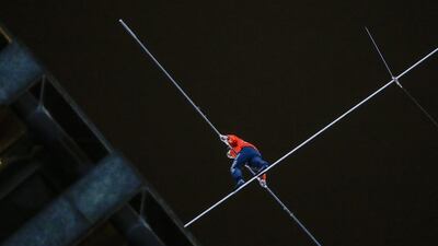 It took Mr Wallenda about six and a half minutes to walk the 138-metre stretch from the Marina City west tower to the top of a building on the other side of the river. Tannen Maury/EPA