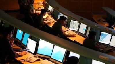 Dubai Police officials working in the Command and Control Center at the Dubai Police Headquarter in Al Qusais in Dubai.