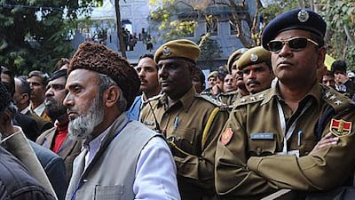 Protesters and policemen listen to an announcement cancelling a video conference with Salman Rushdie at the Jaipur Literature Festival yesterday. The cancellation followed warnings that Muslim groups were threatening attacks if the call went ahead.