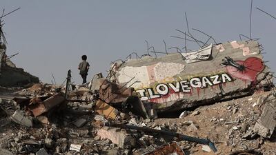 Abdallah Al Areer walks between the rubble of his destroyed home in the east of Gaza City. Mohammed Saber / EPA