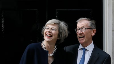 British Prime Minister Theresa May and her husband Philip May stand on the steps of 10 Downing Street in London on July 13, 2016. AP Photo