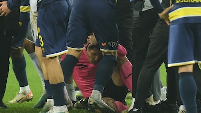 Referee Halil Umut Meler after being after being punched to the ground by Ankaragucu president Faruk Koca. Reuters