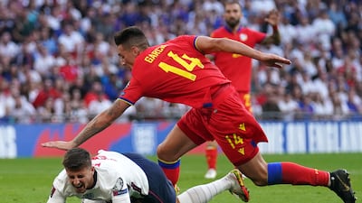 Mason Mount is bundled over by Andorra's Christian Garcia and earns England a penalty. PA