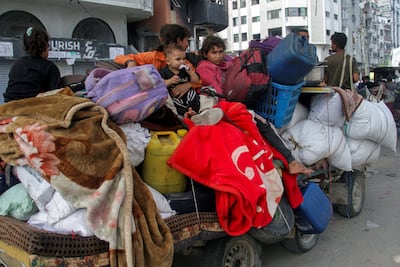 Displaced Palestinians with their belongings crammed on to a cart flee the northern Gaza Strip. Reuters