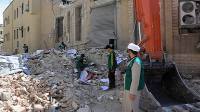 People inspect the debris of a damaged building following air strikes in central Tehran. AFP
