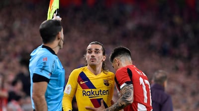 Barcelona's Antoine Griezmannargues with the linesman. AP