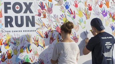 Volunteers prepare for the run on Friday morning on Corniche Beach. All photos by Leslie Pableo for The National