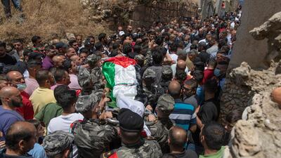 Palestinian security officers carried the body out of the family house. AP Photo