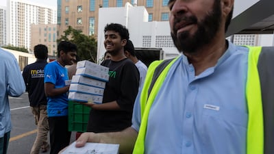 Dar Al Ber Society, the oldest iftar meal distributor in the UAE, hands out food packages in Bur Dubai. Antonie Robertson / The National