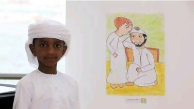 Mohammed Salmin, 8, from Abu Hanifa Boys Primary School, with his winning drawing of a son kissing his father's head.