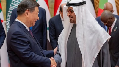 Sheikh Mohamed greets Mr Xi in Beijing.