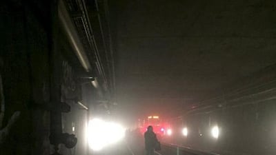 Passengers walk on underground metro tracks to be evacuated after an explosion at Maalbeek train station in Brussels, Belgium. Courtesy @OSOSXE via Twitter / Handout via Reuters