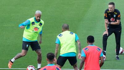 Brazil's Neymar, left, controls the ball during a training session. AP
