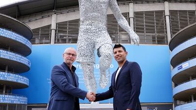 Manchester City legend Sergio Aguero, right, with sculptor Andy Scott during his statue unveiling outside the Etihad Stadium to commemorate the 10th anniversary of the club's first Premier League title and the iconic "93:20" moment. AP