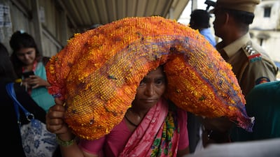 An Indian pedestrian carries flowers through the scene of a stampede on a railway bridge in Mumbai. AFP