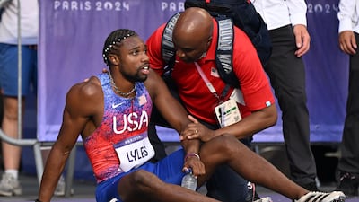 Bronze medallist Noah Lyles receives medical attention after competing in the men's 200m final. AFP
