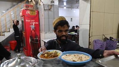 Rozi Khan prepares to serve food to customers at Dilbar Hotel in Rawalpindi. AFP