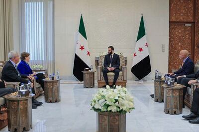 Syrian President Ahmad Al Shara meets US Representative Joe Wilson, left, US Senator Jeanne Shaheen, second left, and US Ambassador to Turkey and Special Envoy to Syria Tom Barrack, right, in Damascus on August 25, 2025. SANA via AP