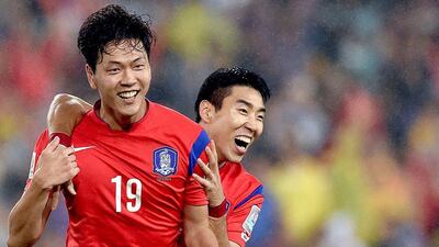 South Korea's Kim Young-gwon, left, is congratulated after scoring by Lee Jeong-hyeop during their 2-0 win over Iraq in the Asian Cup semi-finals on Monday. Paul Miller / EPA / January 26, 2015