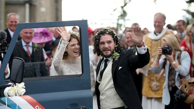 Actors Kit Harington and Rose Leslie get into a Defender as they leave after their wedding ceremony, at Rayne Church, Kirkton of Rayne in Aberdeenshire. Jane Barlow / PA via AP