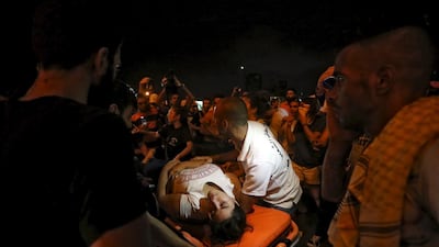 A wounded woman is moved on a stretcher by medics during a protest against corruption and rubbish collection problems near the government palace in Beirut on Saturday. At least 10 people were wounded in clashes between Lebanese security forces and protestors. Hasan Shaaban / Reuters