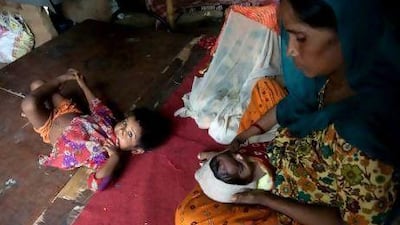 Gira, a Pakistani Hindu, with son Bharat, who was born in India, and Pakistan-born daughter Ram Gori in their temporary shelter in New Delhi.