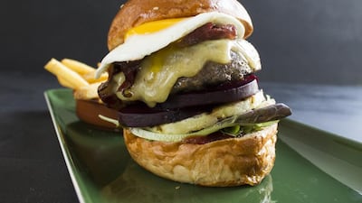 The great Aussie wagyu burger topped with fried egg, pineapple and beetroot is one of the items on Jones the Grocer's Australian-inspired menu. Courtesy Jones the Grocer