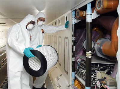 Cleaning staff change air filters aboard an Emirates aircraft to protect passengers against the coronavirus. Photo: AFP
