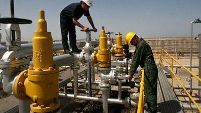 Iranian technicians work in the Azadegan oilfield. The country’s energy sector is under pressure from sanctions. Vahid Salemi / AP Photo