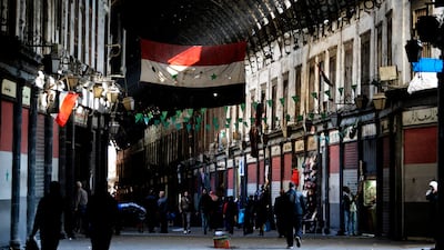 Syrian vendors open their shops at the Hamidiya market in the old part of Damascus. Louai Beshara / AFP