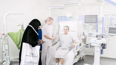 A woman stands by an advertisement at the 41st edition of Arab Health Exhibition & Congress, the Middle East's largest healthcare event, which is being held at the Dubai International Convention and Exhibition Centre. Photo by Reem Mohammed