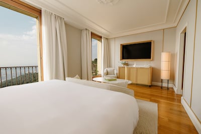 Deluxe rooms feature pale wood, soft fabrics and floor-to-ceiling windows that open to private balconies. Photo: Mett Barcelona