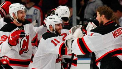New Jersey Devils players celebrate their 5-3 win over the New York Rangers.