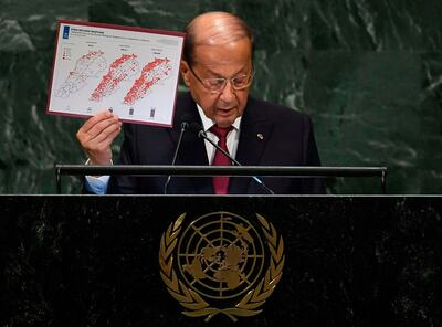 Michel Aoun, President of Lebanon, displays a graphic depicting the number of registered Syrian refugees in Lebanon between 2012 and 2014 as he addresses the United Nations General Assembly. AFP