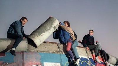 On November 16, 1989 shows young West Berliners remove a piece of the Berlin Wall. (Patrick Hertzog / AFP)