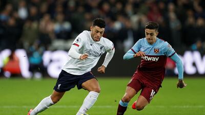 Liverpool's Alex Oxlade-Chamberlain with West Ham United's Manuel Lanzini. Reuters