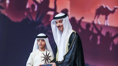 Sheikh Humaid bin Rashid is given an award by Sheikh Hazza bin Zayed. Victor Besa / The National