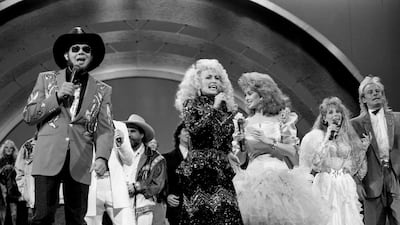 Parton is joined by other stars at the CMA Awards show in Nashville in 1988. Reuters